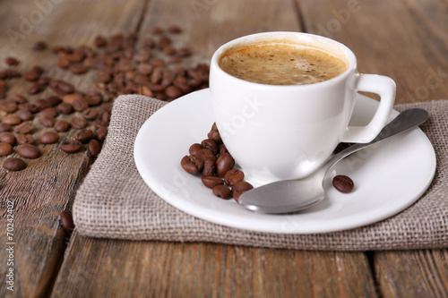 Cup of coffee with milk and coffee beans