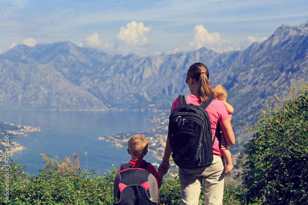 mother with kids looking at mountains on vacation