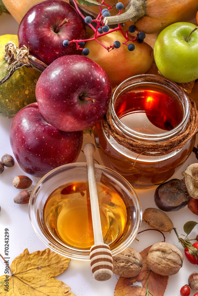 Honey, apples and autumn fruits on the white background Honey, apples and autumn fruits on the white background