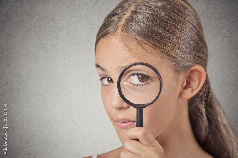 Child looking through a magnifying glass Child looking through a magnifying glass