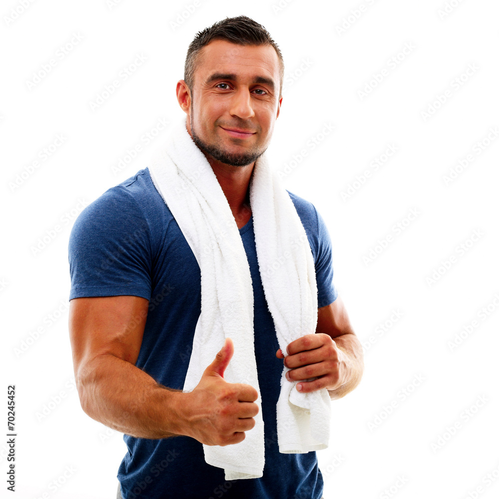 Portrait of a happy sportsman with towel showing thumb up Portrait of a happy sportsman with towel showing thumb up