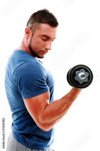 Handsome muscular man doing exercises with dumbbell