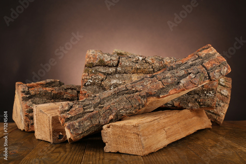 Valokuvatapetti Heap of firewood on floor on dark background