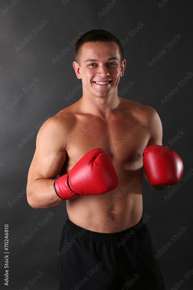 Handsome young muscular sportsman with boxing gloves Handsome young muscular sportsman with boxing gloves