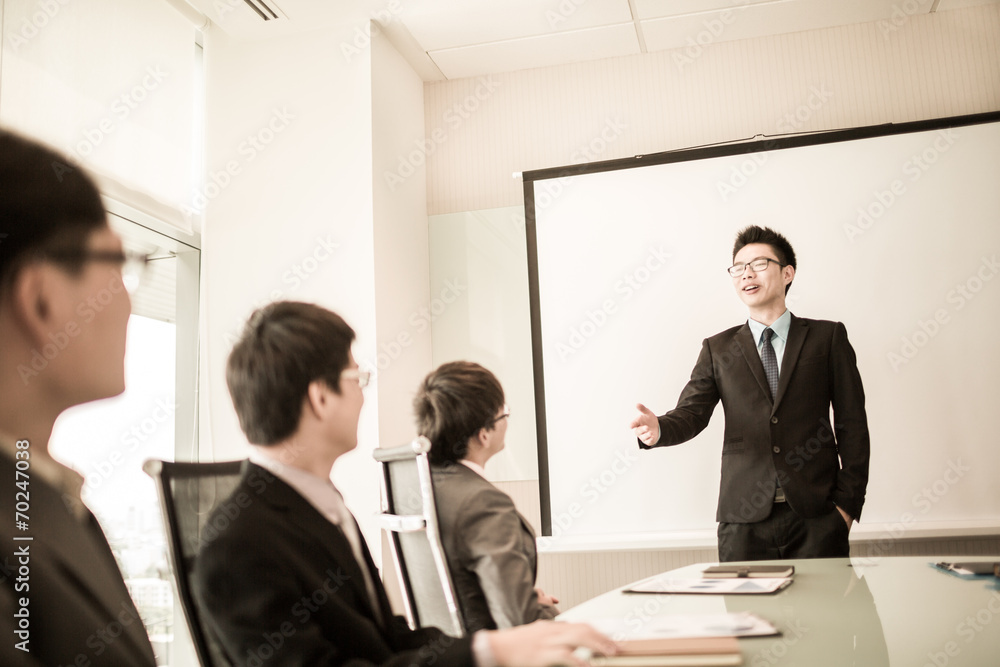 businessman giving a presentation to his colleagues businessman giving a presentation to his colleagues