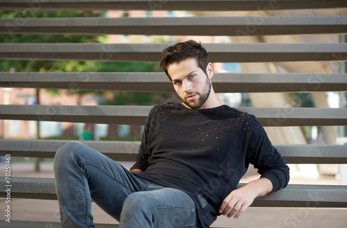 Cool guy sitting on steps outdoors