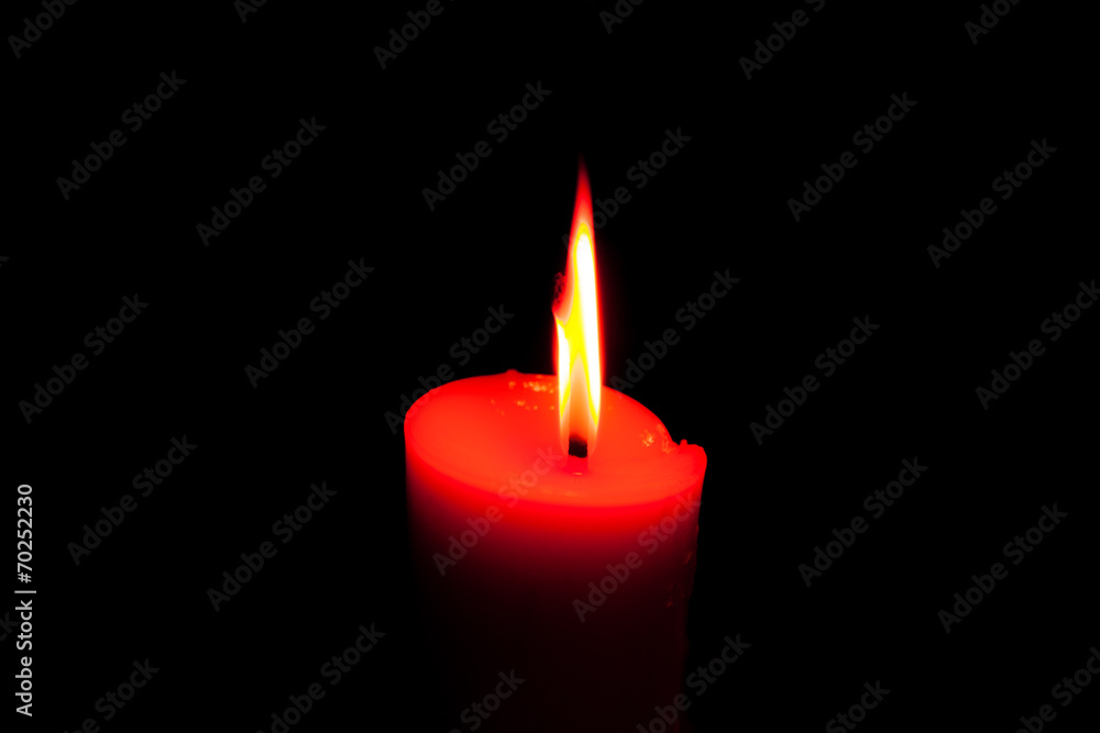 A burning candle in dark. A burning candle in dark.