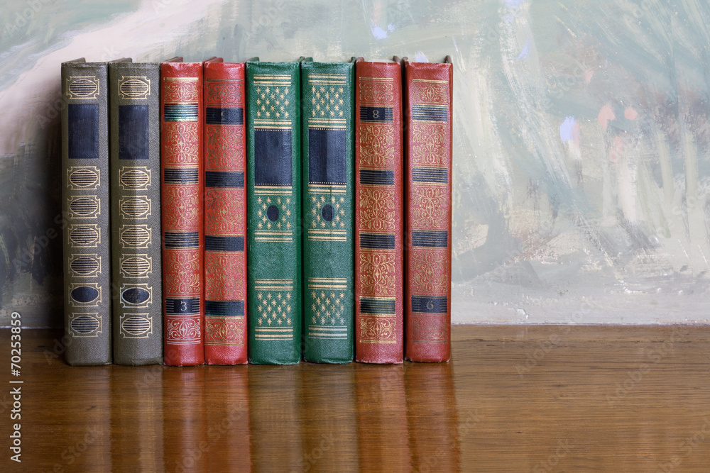 Naklejka premium Richly decorated volumes of books with a gold lettering on the b