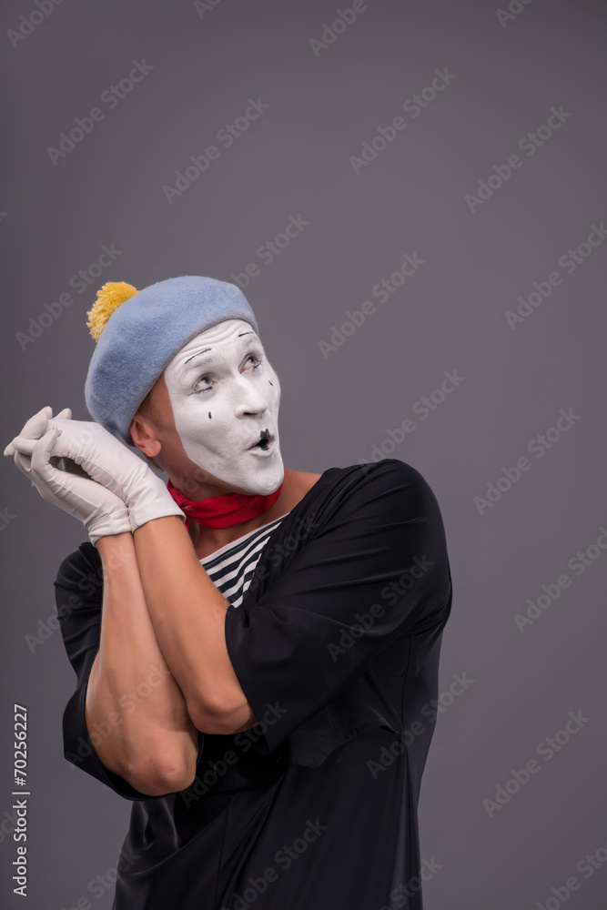 Portrait of young mime boy showing something with his hands Portrait of young mime boy showing something with his hands