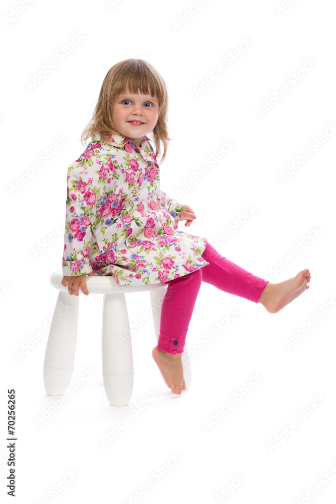 Little girl sitting on a chair in the studio Little girl sitting on a chair in the studio