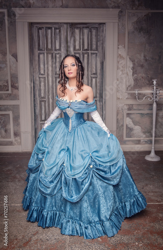 Beautiful medieval woman in long blue dress