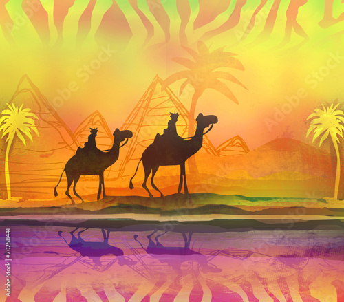 Camel train silhouetted against colorful sky crossing the Sahara