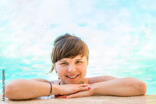 Portrait of a cheerful and beautiful girl in the pool water