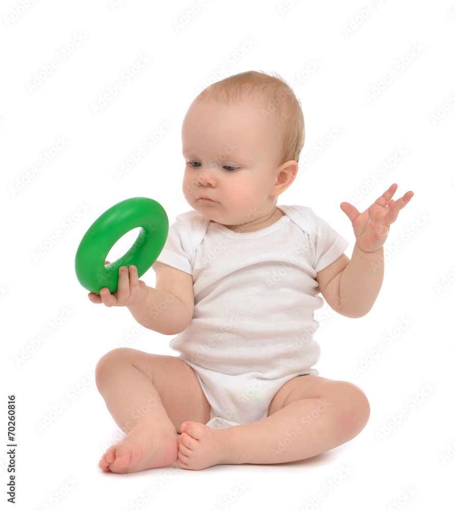 Infant child baby boy toddler playing holding green circle Infant child baby boy toddler playing holding green circle
