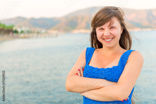 beautiful young girl laughing on the sea background