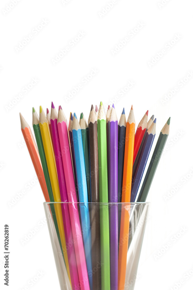 colored pencils in a glass isolated on white background colored pencils in a glass isolated on white background