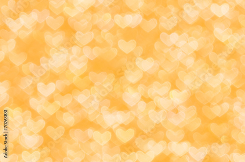 defocused abstract orange hearts light background