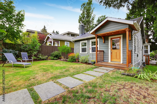 Grey old house with wooden trim