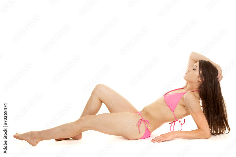 brunette woman pink bikini lay back hand hair