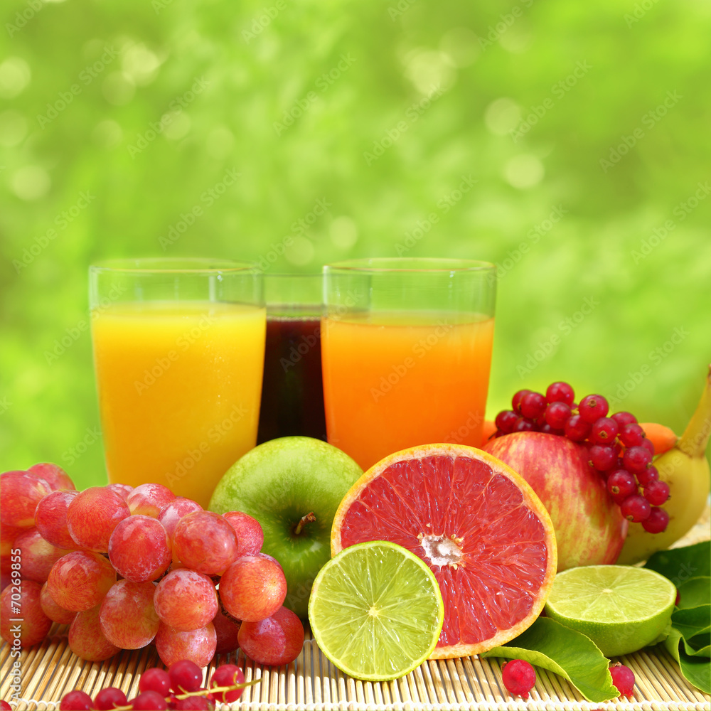 Fresh fruit and three glasses full of juice Fresh fruit and three glasses full of juice