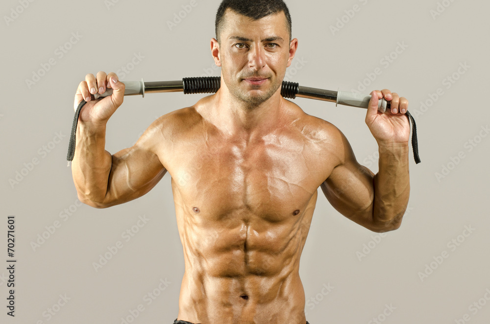 Strong bodybuilder with perfect abs, shoulders,biceps, triceps Strong bodybuilder with perfect abs, shoulders,biceps, triceps
