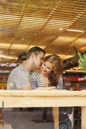 lovely couple sitting indoors in cafe (view through the glass) © Mila Supinskaya 