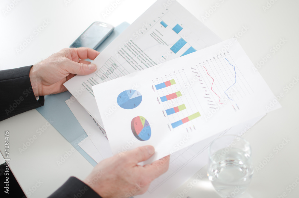 Businessman analyzing economic documents Businessman analyzing economic documents