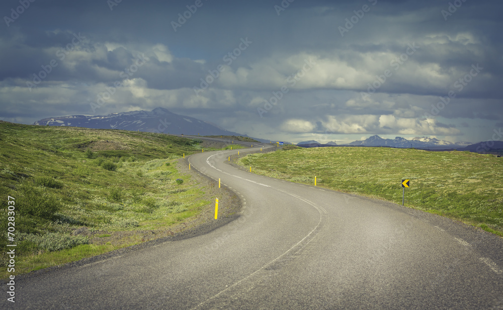 Fototapeta premium Curved asphalt road in high mountains of Iceland