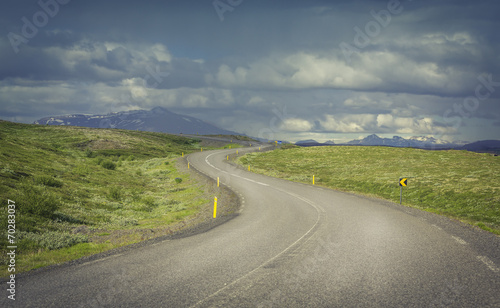 Curved asphalt road in high mountains of Iceland