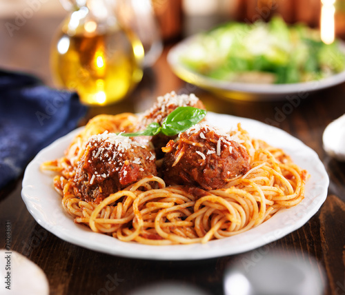 italian food - spaghetti and meatballs at dinner table