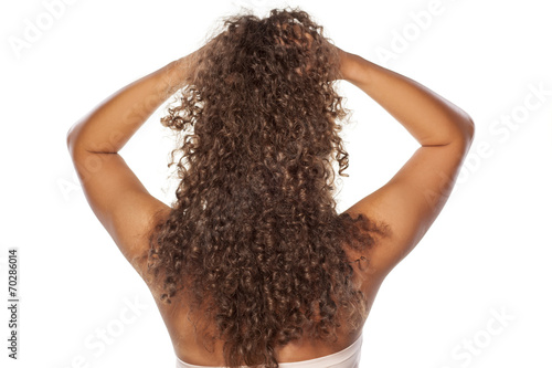 rear view of a young woman with a long curly hair