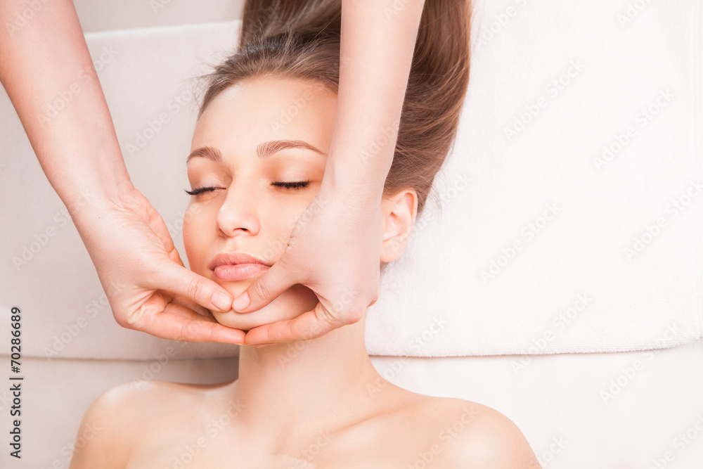 Young bright woman receiving head massage Young bright woman receiving head massage