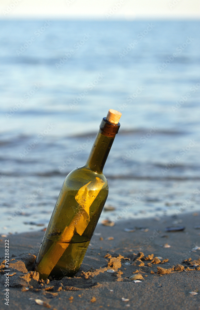 bottle with a secret message on the shore of sandy beach bottle with a secret message on the shore of sandy beach