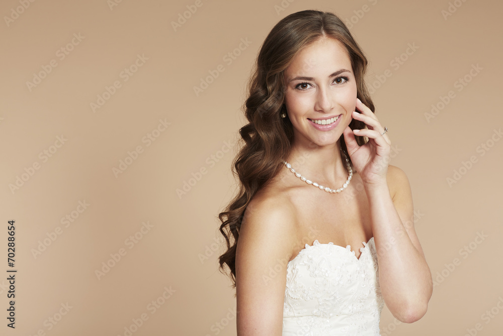 Young bride in wedding dress, studio shot . Young bride in wedding dress, studio shot .