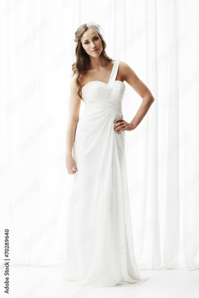Young bride in wedding dress, studio shot . Young bride in wedding dress, studio shot .