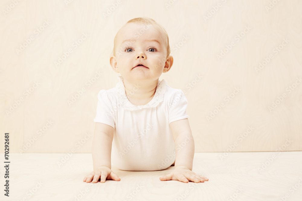 Baby girl looking up, studio shot.