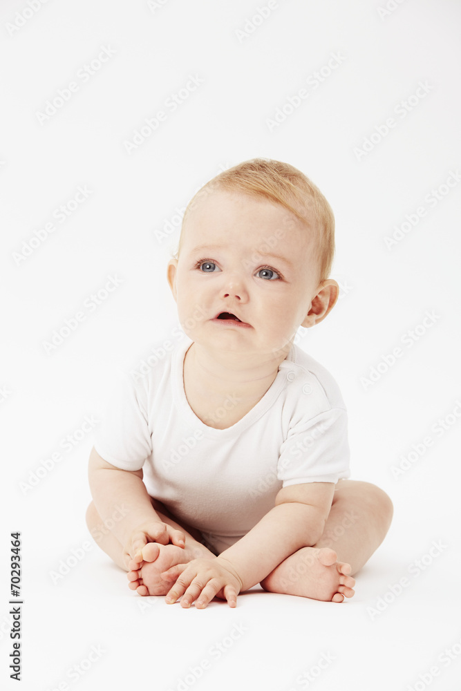 Young baby girl looking up, studio. Young baby girl looking up, studio.
