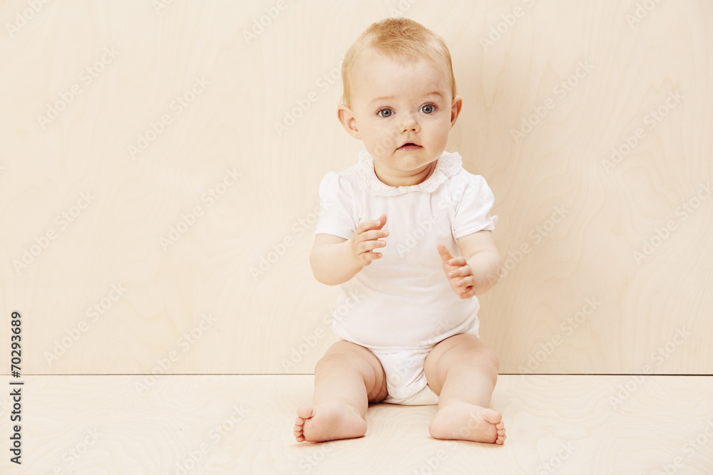 Baby girl reaching out, studio shot. Baby girl reaching out, studio shot.