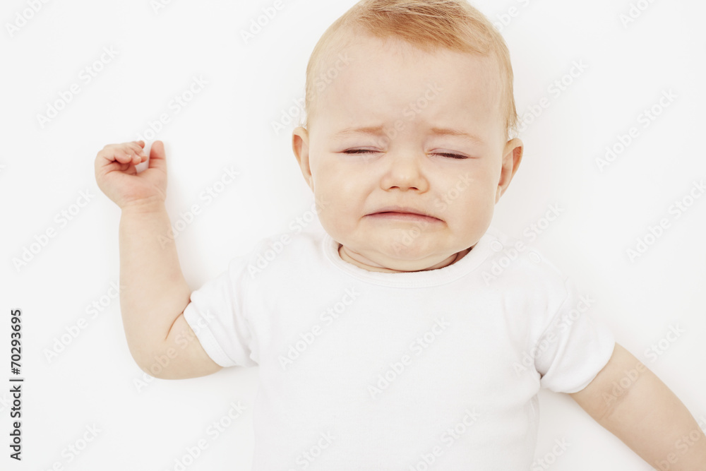 Young baby girl crying, against white background. Young baby girl crying, against white background.