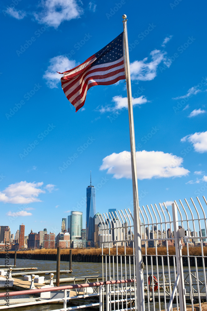 American flag with Manhattan skyline at background