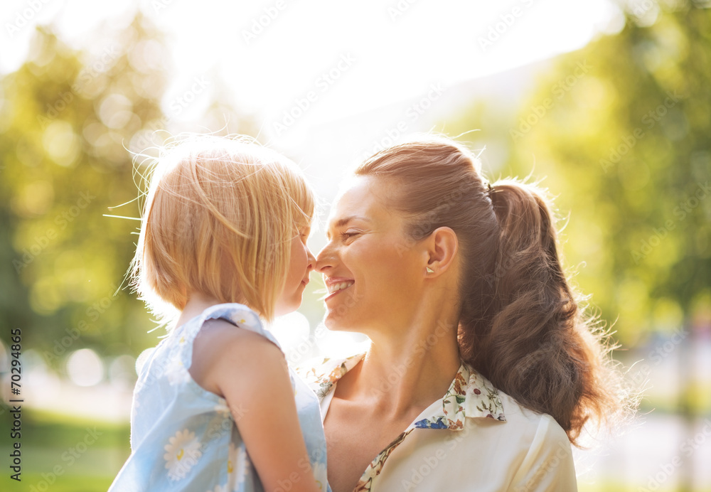 Portrait of happy mother and baby girl outdoors
