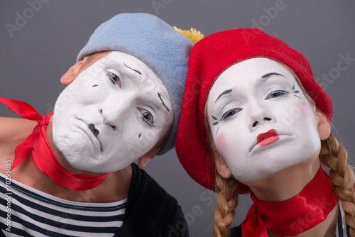 Vászonkép Portrait of sad mime couple crying isolated on grey background