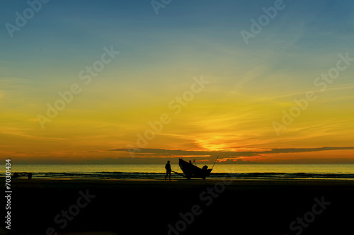 fisherman at beach during sunrise