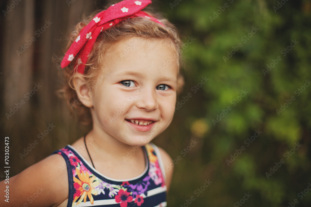 smiling little girl in colorful headband smiling little girl in colorful headband