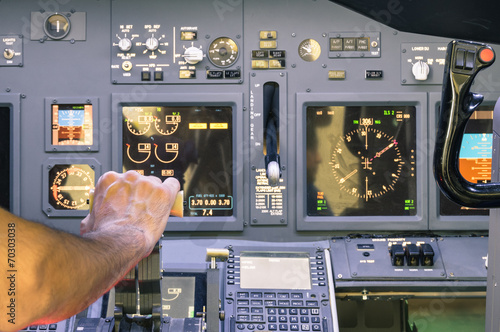 Captain hand accelerating on the throttle in commercial airliner