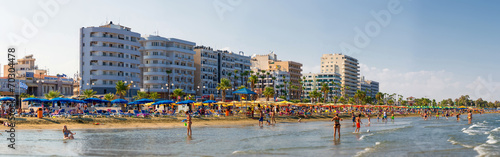 LARNACA, CYPRUS - 20 AUGUST 2014: People on the sunny beach of L photo