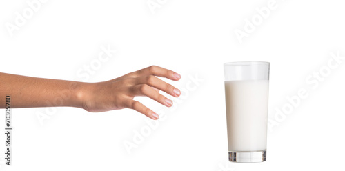 Young girl hand with a glass of milk