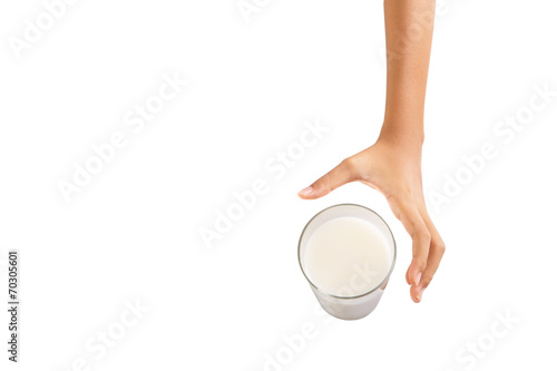 Young girl hand with a glass of milk