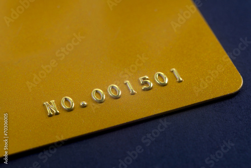 closeup gold credit card with embossed number