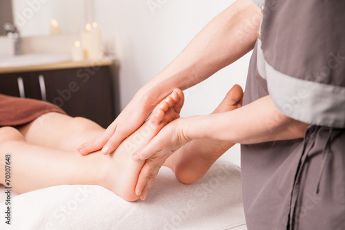 Foot massage for a woman in luxury spa